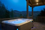 A six man hot tub has a view of the mountains.